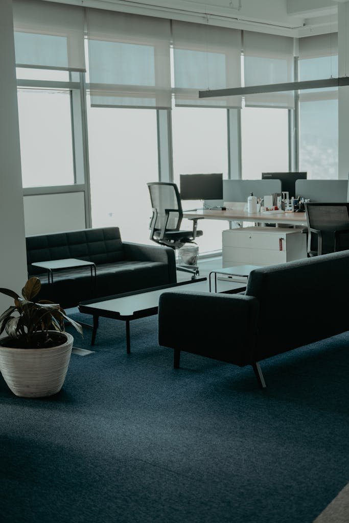 A stylish office space with leather sofas and large windows. Perfect for business settings.